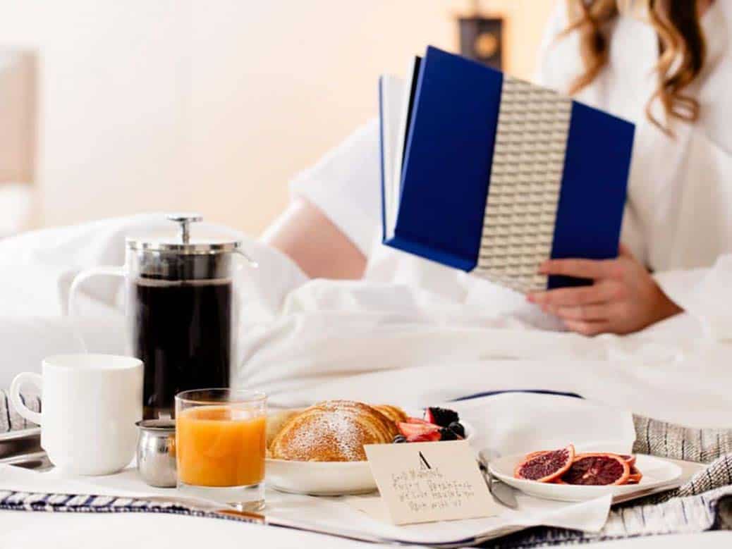 Hotel guest lady having breakfast at Ambassador Chicago room - example of great hotel photography using people