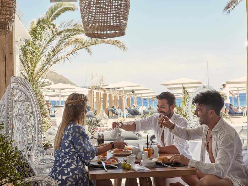 Example of good hotel photography showing happy guests at breakfast at Mykonos Ammos hotel in Greece