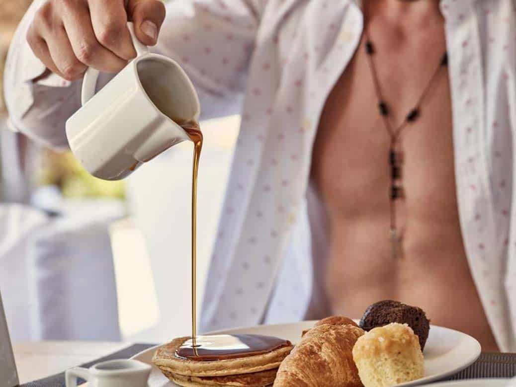 Example of good hotel photography showing satisfied guest at breakfast at Mykonos Ammos hotel in Greece